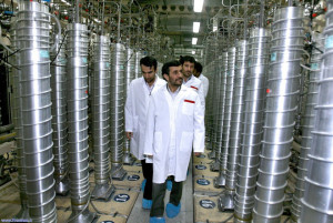 In this photo released by the Iranian President's Office, Iranian President Mahmoud Ahmadinejad, center, visits the Natanz Uranium Enrichment Facility some 200 miles (322 kilometers) south of the capital Tehran, Iran, Tuesday, April 8, 2008. Ahmadinejad announced major progress in Iran's push for nuclear power, saying Tuesday that his nation was installing thousands of new uranium-enriching centrifuges and testing a much faster version of the device. (AP Photo/Iranian President's Office)